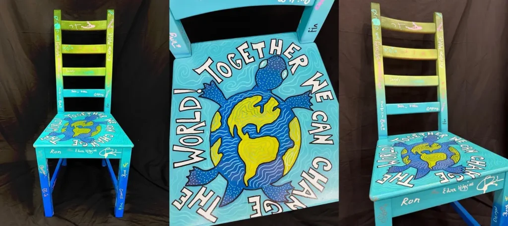 Image of painted chair depicting a turtle with the earth as its shell.